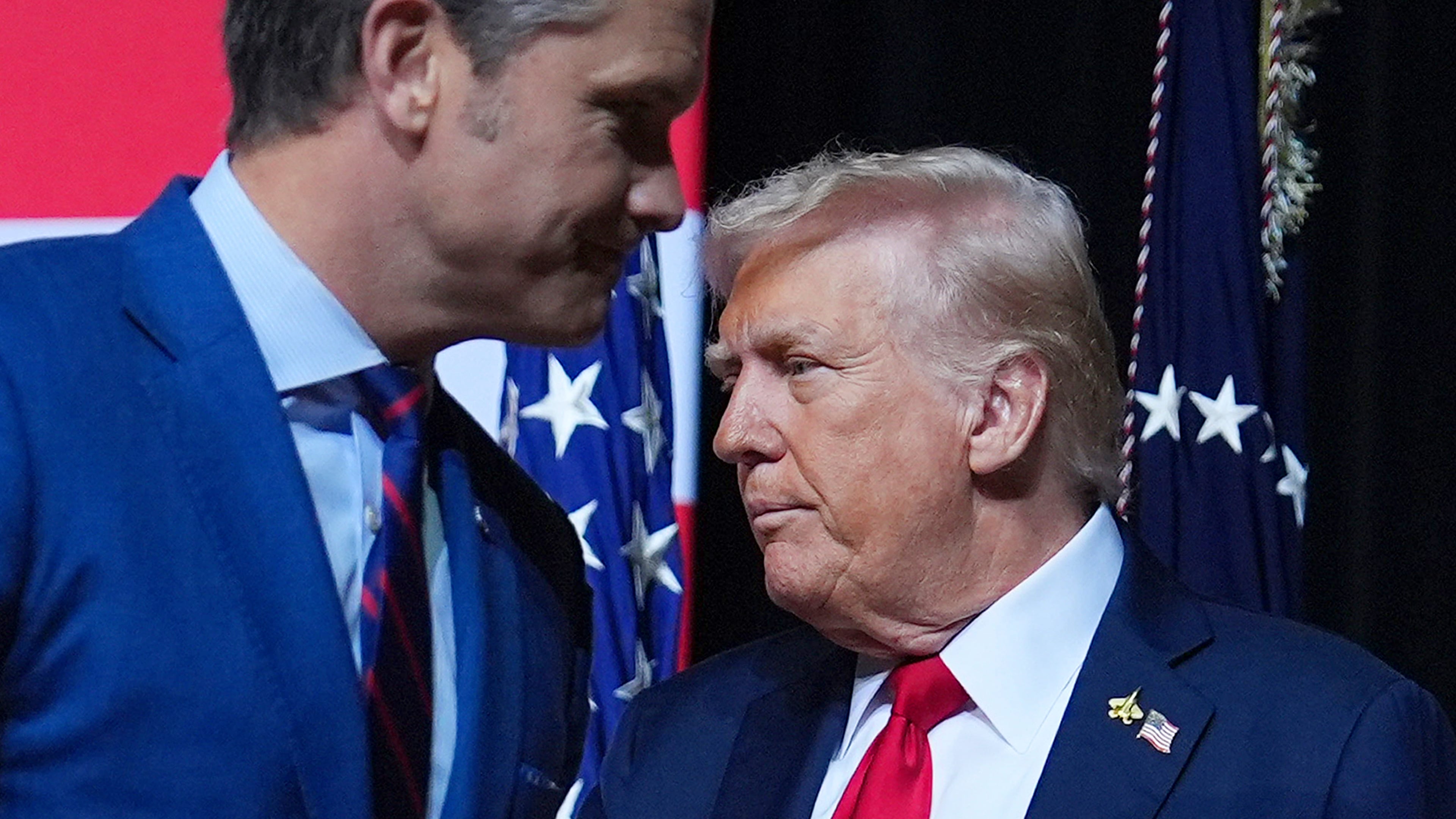 President Donald Trump is greeted by Secretary of Defense Pete Hegseth before speaking to a gathering of top U.S. military commanders at Marine Corps Base Quantico, Tuesday, Sept. 30, 2025, in Quantico, Va. (AP Photo/Evan Vucci)