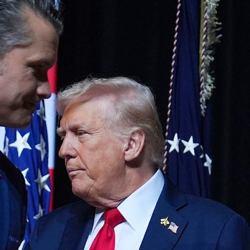 President Donald Trump is greeted by Secretary of Defense Pete Hegseth before speaking to a gathering of top U.S. military commanders at Marine Corps Base Quantico, Tuesday, Sept. 30, 2025, in Quantico, Va. (AP Photo/Evan Vucci)