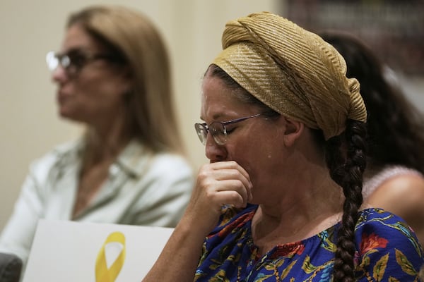 A woman reacts to testimony by freed hostage Ilana Gritzewsky at a ceremony presenting a report by the Dinah Project on sexual violence committed on Oct. 7, 2023 by Hamas, to Israel's first lady Michal Herzog, in Jerusalem, Tuesday, July 8, 2025. (AP Photo/Maya Alleruzzo)