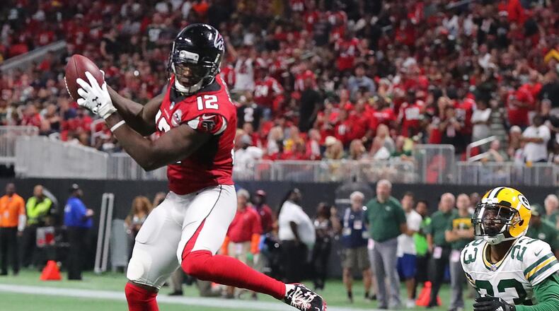 In the Falcons 2017 home opener, wide receiver Mohamed Sanu takes flight for a first down catch against Green Bay's Damarious Randall. (Curtis Compton/ccompton@ajc.com)