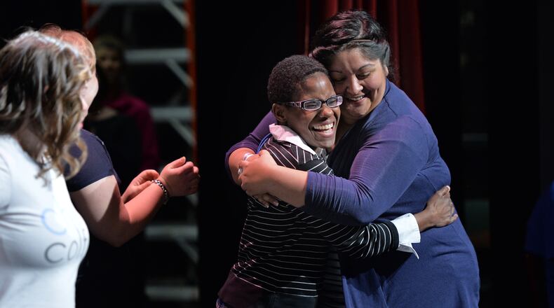 Katherine Burnette gets a hug from actress Katie Cathell (right) before their rehearsal for Little Shop of Horrors at the Jerry's Habima Theatre company, at the Marcus Jewish Community Center of Atlanta in 2014. HYOSUB SHIN / HSHIN@AJC.COM