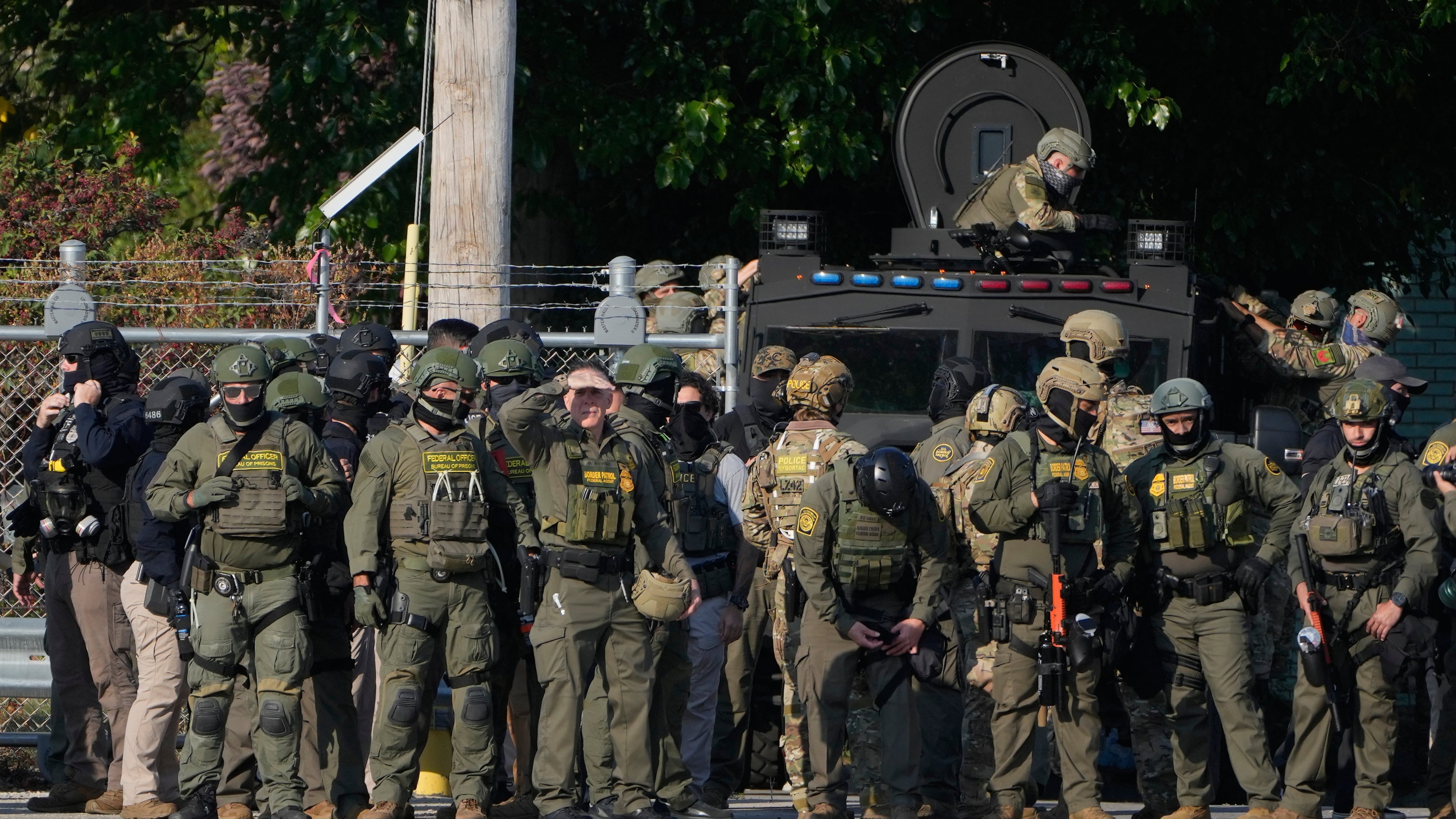 FILE - Greg Bovino, the chief patrol agent for the U.S. Border Patrol El Centro sector, center, stands with federal immigration agents near an Immigration and Customs Enforcement facility in Broadview, Ill., Oct. 3, 2025. (AP Photo/Erin Hooley, File)