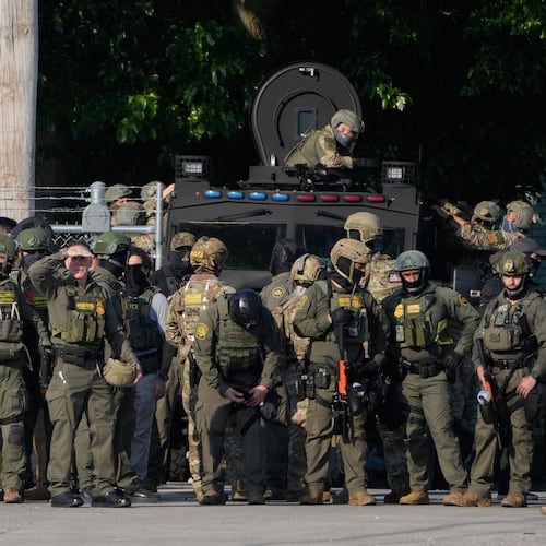FILE - Greg Bovino, the chief patrol agent for the U.S. Border Patrol El Centro sector, center, stands with federal immigration agents near an Immigration and Customs Enforcement facility in Broadview, Ill., Oct. 3, 2025. (AP Photo/Erin Hooley, File)