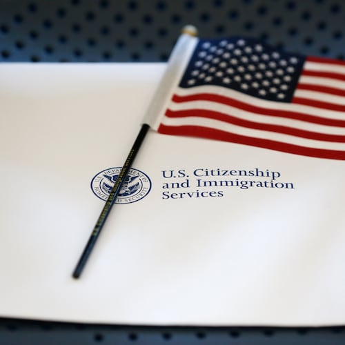 FILE - An information packet and an American flag are placed on a chair at the U.S. Citizenship and Immigration Services Miami Field Office on Aug. 17, 2018, in Miami. (AP Photo/Wilfredo Lee, File)
