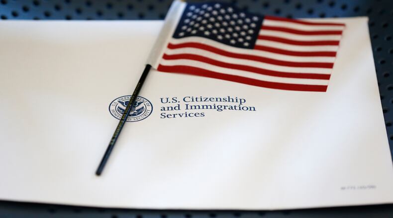 FILE - An information packet and an American flag are placed on a chair at the U.S. Citizenship and Immigration Services Miami Field Office on Aug. 17, 2018, in Miami. (AP Photo/Wilfredo Lee, File)