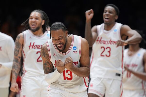 Houston's J'Wan Roberts (13) celebrates with teammates including Emanuel Sharp, left, and Terrance Arceneaux (23) in the final minutes of a victory over Tennessee in the Elite Eight round of the NCAA college basketball tournament Sunday, March 30, 2025, in Indianapolis. (AP Photo/Michael Conroy)