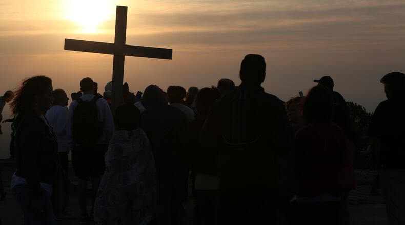 April 16, 2017, Atlanta, Georgia - Visitors gather around the cross at the top of the mountain after the Easter Sunrise Service at Stone Mountain Park in Stone Mountain, Georgia, on April 16, 2017. (HENRY TAYLOR / HENRY.TAYLOR@AJC.COM)