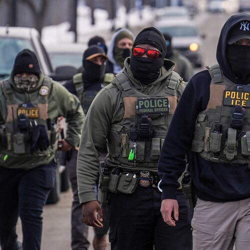 FILE - Federal agents walk down a street while conducting immigration enforcement operations in Minneapolis, Feb. 5, 2026. (AP Photo/Ryan Murphy, File)