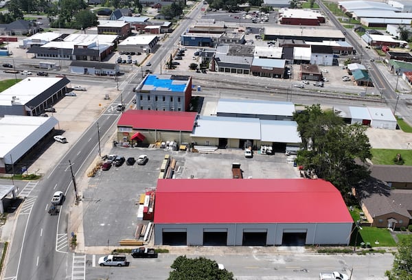 The damage from Hurricane Helene has been repaired in some places in downtown Hazlehurst — the red roofs are new — however blue tarps remain on some roofs nearly a year after the storm. (Hyosub Shin/AJC)