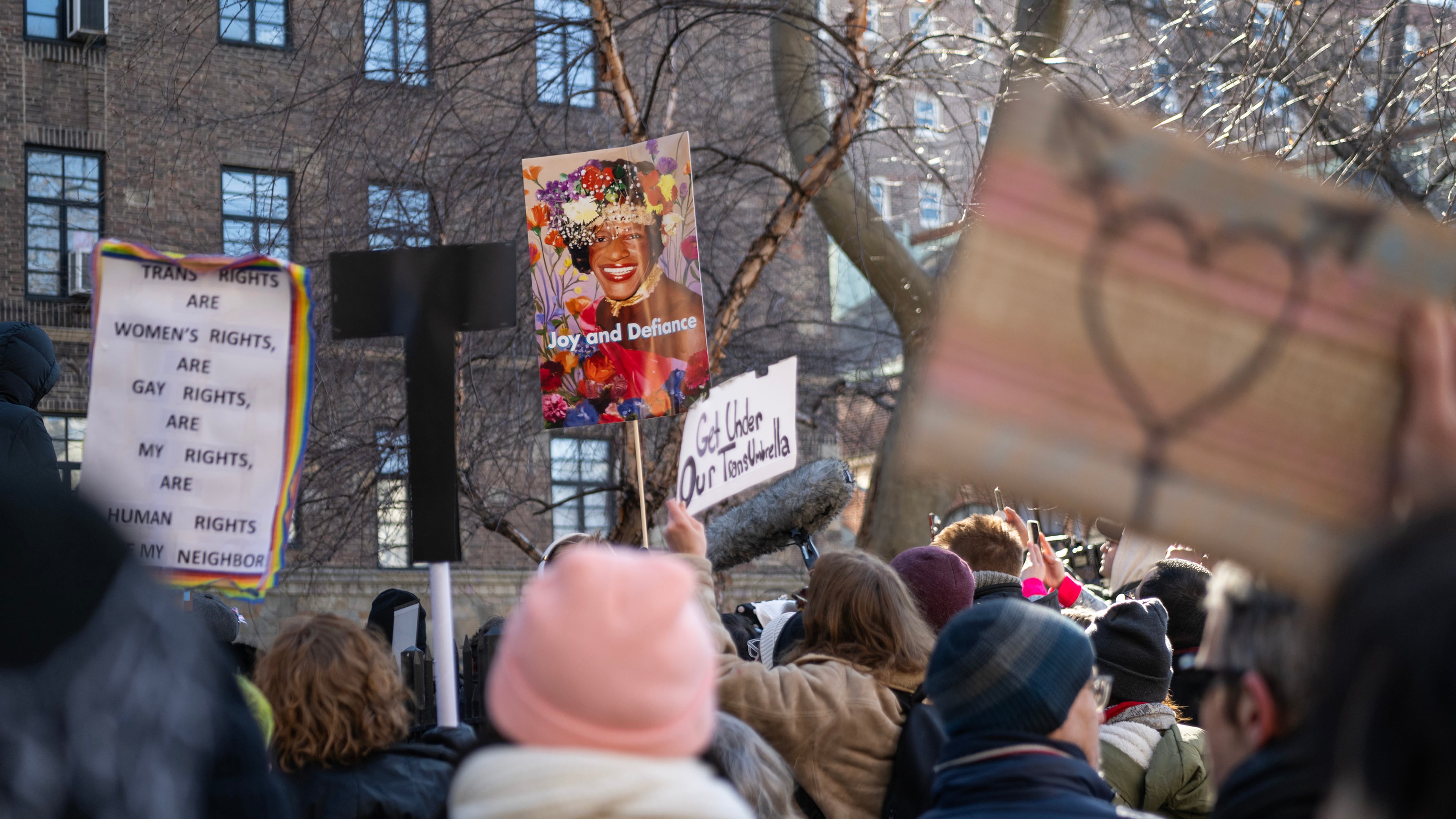 Protesters carry placards of Marsha P. Johnson, a transgender woman whose legacy of activism is memorialized at the Stonewall National Monument in the Greenwich Village neighborhood of New York, Feb. 14, 2025. Hundreds of people gathered at the Greenwich Village site to condemn what they saw as a chilling strike against the symbolic heart of the gay rights movement. (Brittainy Newman/The New York Times)
