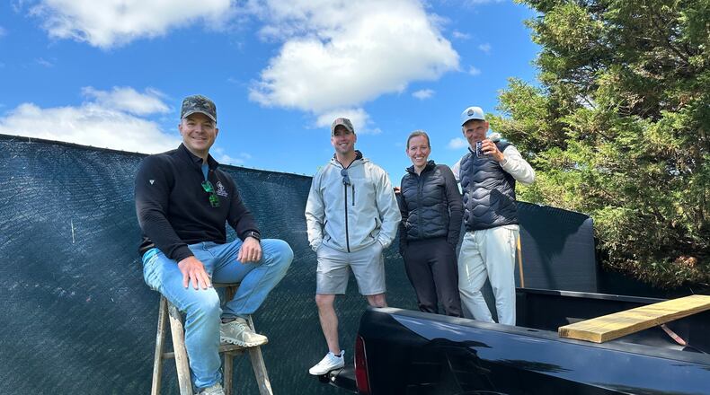 Golf fans pose for a photo while watching the PGA Championship golf tournament from pickup trucks and ladders from neighborhood homes outside Aronimink Golf Club, Friday, May 15, 2026 in Newtown Square, Pa. (AP Photo/Dan Gelston)