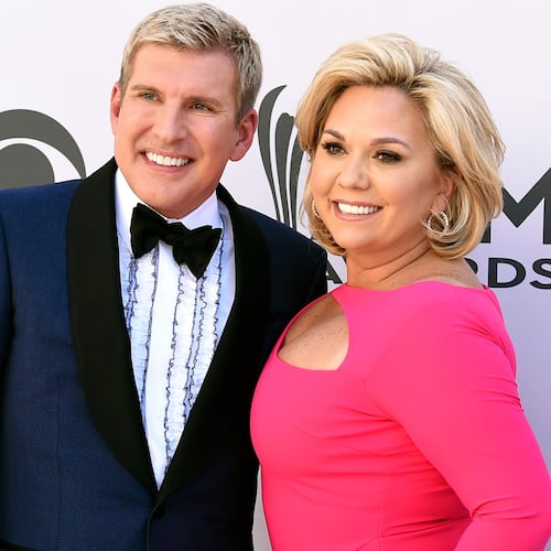 FILE - Julie Chrisley, right, and her husband Todd Chrisley pose for photos at the 52nd annual Academy of Country Music Awards in Las Vegas April 2, 2017. (Jordan Strauss/Invision/AP, File)