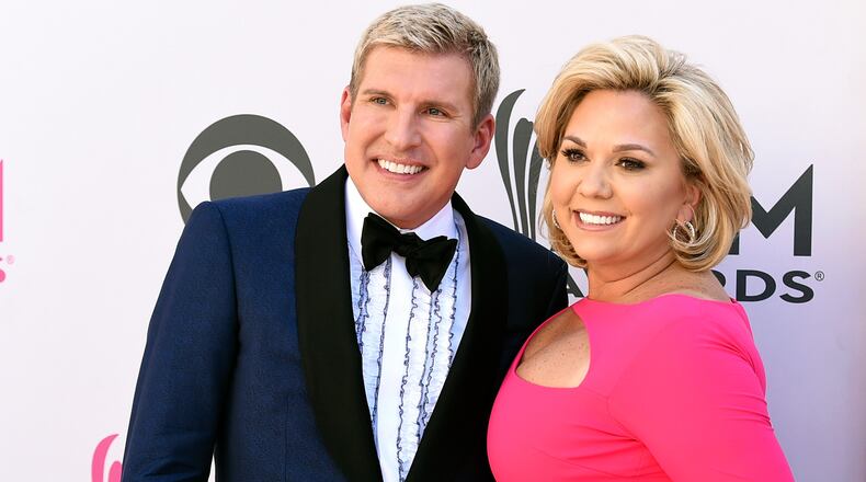 FILE - Julie Chrisley, right, and her husband Todd Chrisley pose for photos at the 52nd annual Academy of Country Music Awards in Las Vegas April 2, 2017. (Jordan Strauss/Invision/AP, File)