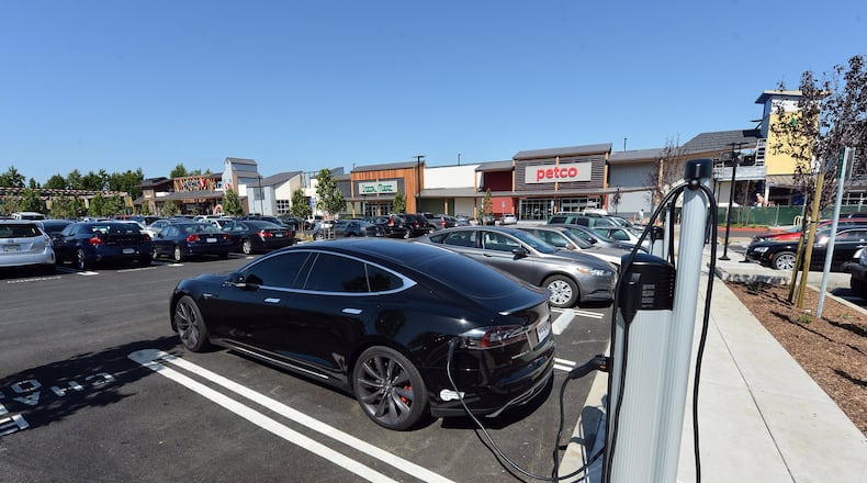 A Tesla charges at one of the electric vehicle charging stations in The Orchards shopping center in Walnut Creek, Calif., on Wednesday, Sept. 14, 2016. (Kristopher Skinner/Bay Area News Group/TNS)