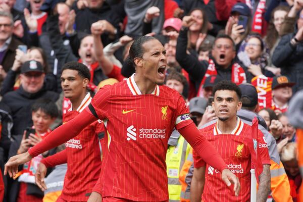 Liverpool's Virgil van Dijk celebrates after scoring his side's second goal during the English Premier League soccer match between Liverpool and West Ham United at Anfield in Liverpool, Sunday, April 13, 2025. (AP Photo/Ian Hodgson)