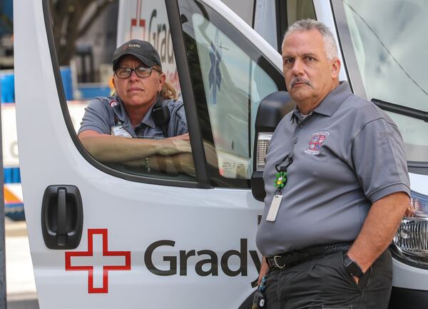 May 19, 2020 Atlanta: 21-year Grady EMS Paramedic, Tracy Arnold (left) and 37-year EMT, Daniel Weed (right). Paramedic Tracy Arnold reflected on the pandemic saying, " I think the services really try to do the best we can with the knowledge that we have and obviously being at Grady they have really helped with protecting us, protecting our patients. Grady EMS goes back years and years of helping their grandmothers and their aunties and their kids, and seeing their kids being born. They've see Grady paramedics and EMT's in their homes for 100-years, and what I've noticed in the last 2-months during this pandemic, is people are nervous. They see us and they know us. Lots of people know who we are and they're nervous when they see us come out with the face shields, and the gowns and the masks. And they really just want our input in to what to do and if they need to go to the hospital or the clinic, so they're nervous, as probably as much as we are. We don't want to take it home to our families and our kids. But we're doing the best we can and that's all we can do."  EMT, Daniel Weed began his career at 19-years old and said of the pandemic, "Just trying to help people, trying to educate people so they know what to do and how to stay safe. The pandemic, I was here for the first one which would've been HIV back in the 80's when we first started wearing gloves." JOHN SPINK/JSPINK@AJC.COM