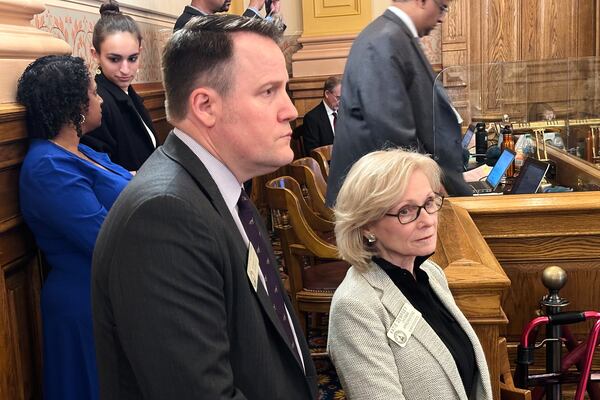 Georgia state Reps. Scott Holcomb, D-Atlanta, left, and Katie Dempsey, R-Rome, listen as senators debate a bill at the state Capitol in Atlanta on Friday, April 4, 2025. (AP Photo/Jeff Amy)