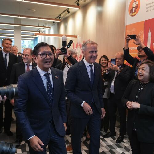 Canada's Prime Minister Mark Carney, center, and Philippines President Ferdinand Marcos Jr., right, arrive for a visit to a Jollibee fast food restaurant, in Vancouver, Thursday, July 2, 2026. (Darryl Dyck/The Canadian Press via AP)
