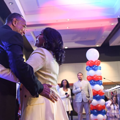Keisha Lance Bottoms (right), the Democratic nominee for governor in Georgia, hugs her husband, Derek, after winning the primary Tuesday. (Natrice Miller/AJC)
