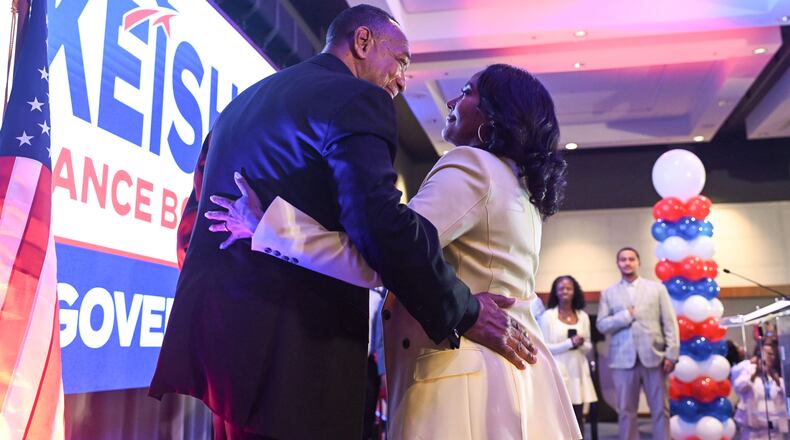 Keisha Lance Bottoms (right), the Democratic nominee for governor in Georgia, hugs her husband, Derek, after winning the primary Tuesday. (Natrice Miller/AJC)