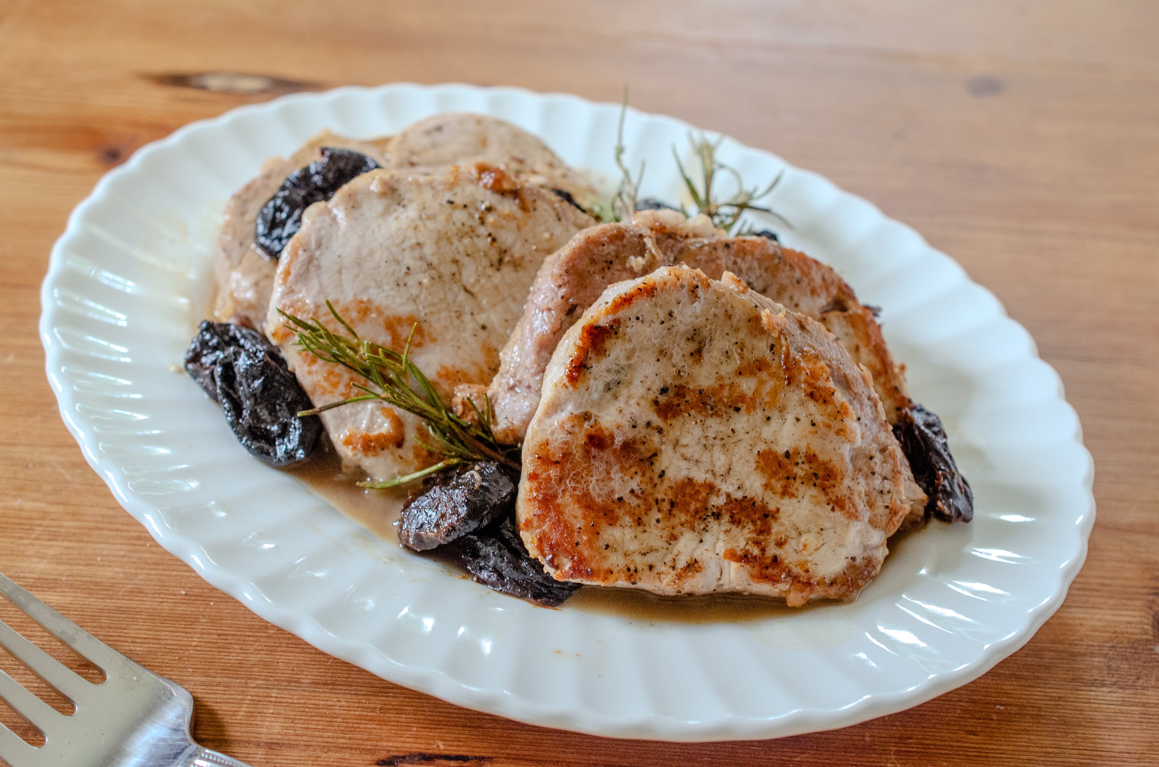 A kosher salt brine turns out juicy pork jobs with prunes and rosemary. (Virginia Willis for the AJC)