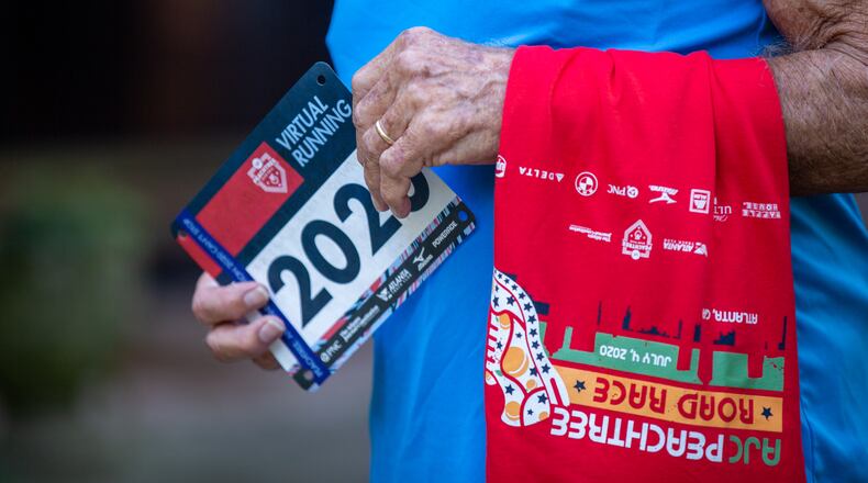 Bill Thorn holds a race tag and his t-shirt in Tyrone, Georgia, on Tuesday, October 13, 2020. Bill Thorn was presented the t-shirt for the annual Peachtree Road Race on Tuesday by the Atlanta Track Club. (Photo/Rebecca Wright for the Atlanta Journal-Constitution)