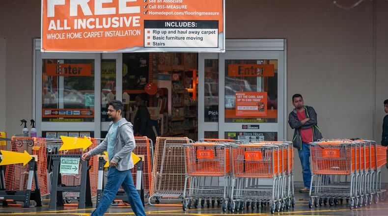 Patrons gather outside of The Home Depot to gather supplies in Dunwoody. The Home Depot has been letting a limited number of people into their store during the spread of COVID-19. (Photo/Rebecca Wright for the AJC)