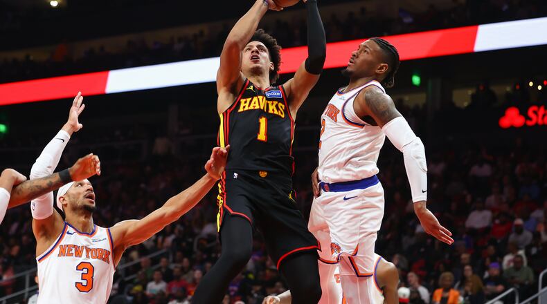 Atlanta Hawks forward Jalen Johnson (1) goes up to shoot against New York Knicks guards Josh Hart (3) and Miles McBride, right, during the first half of an NBA basketball game, Monday, April. 6, 2026, in Atlanta. (Colin Hubbard/AP)