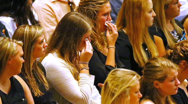 Friends and loved ones weep during a service for Emily Elizabeth Clark in April 2015. Clark and four other nursing students from Georgia Southern University were killed in a multi-vehicle accident on I-16. Curtis Compton / ccompton@ajc.com