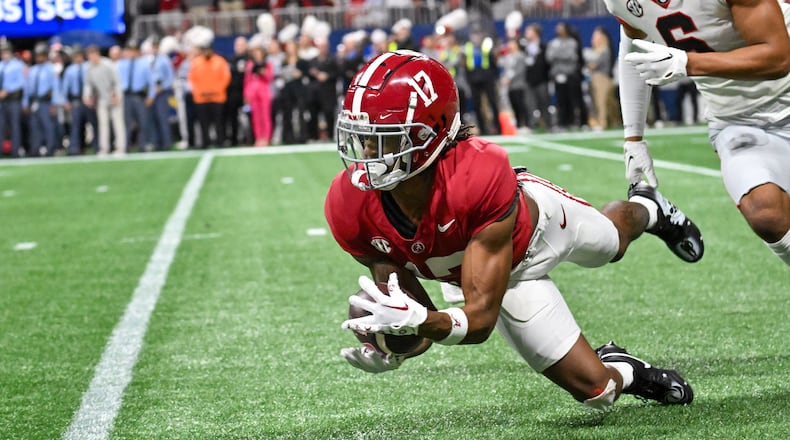 Alabama Crimson Tide wide receiver Isaiah Bond (17) makes a catch in front of Georgia Bulldogs defensive back Daylen Everette (6) during the first half of the SEC Championship football game at the Mercedes-Benz Stadium in Atlanta, on Saturday, December 2, 2023. (Hyosub Shin / Hyosub.Shin@ajc.com)