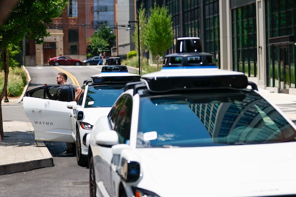 A pasanger is seen getting out of the self-driving Waymo vehicle at Ponce City Market in Atlanta on Monday, June 23, 2025. 
(Miguel Martinez/ AJC)