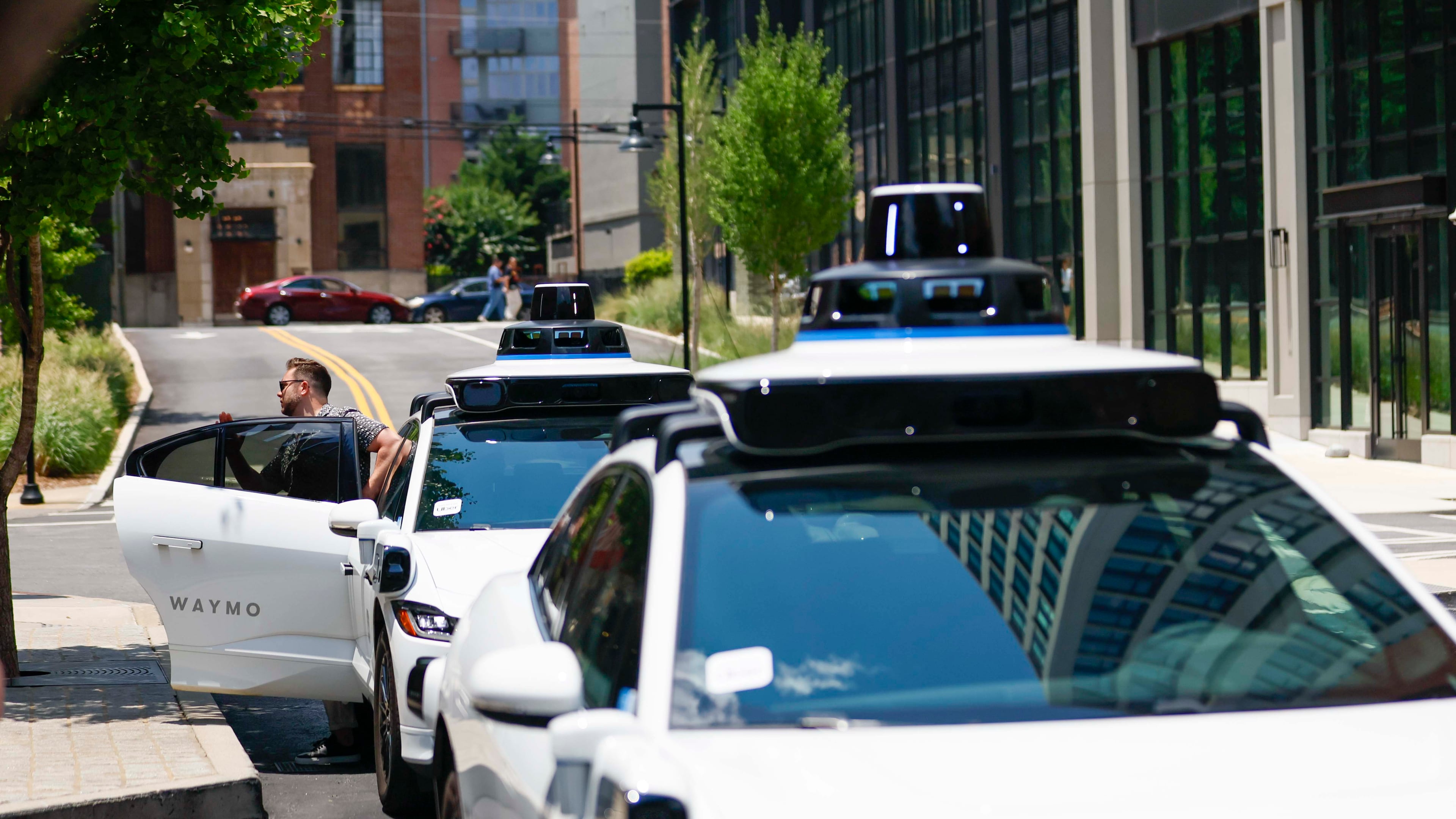 A passenger gets out of the self-driving Waymo at Ponce City Market in Atlanta on Monday, June 23, 2025. (Miguel Martinez/ AJC)