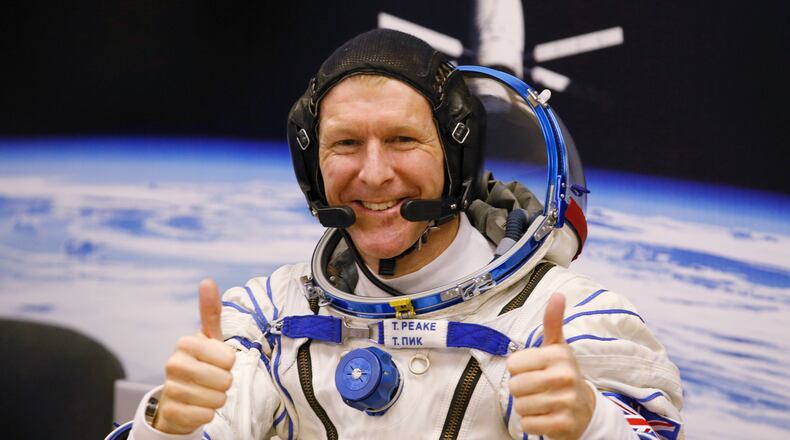 FILE - In this Tuesday, Dec. 15, 2015 file photo, British astronaut Tim Peake, member of the main crew of the expedition to the International Space Station (ISS), gestures prior the launch of Soyuz TMA-19M space ship at the Russian leased Baikonur cosmodrome, Kazakhstan. Anyone can dial a wrong number, but it’s not often done from outer space. Peake tweeted an apology on Christmas Day from the International Space Station after calling a wrong number. (AP Photo/Dmitry Lovetsky, File)