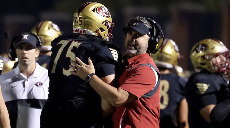 Former Johns Creek head coach Matt Helmerich, now at Peachtree Ridge, celebrates a touchdown during the second half of a 2021 game against Riverwood.
