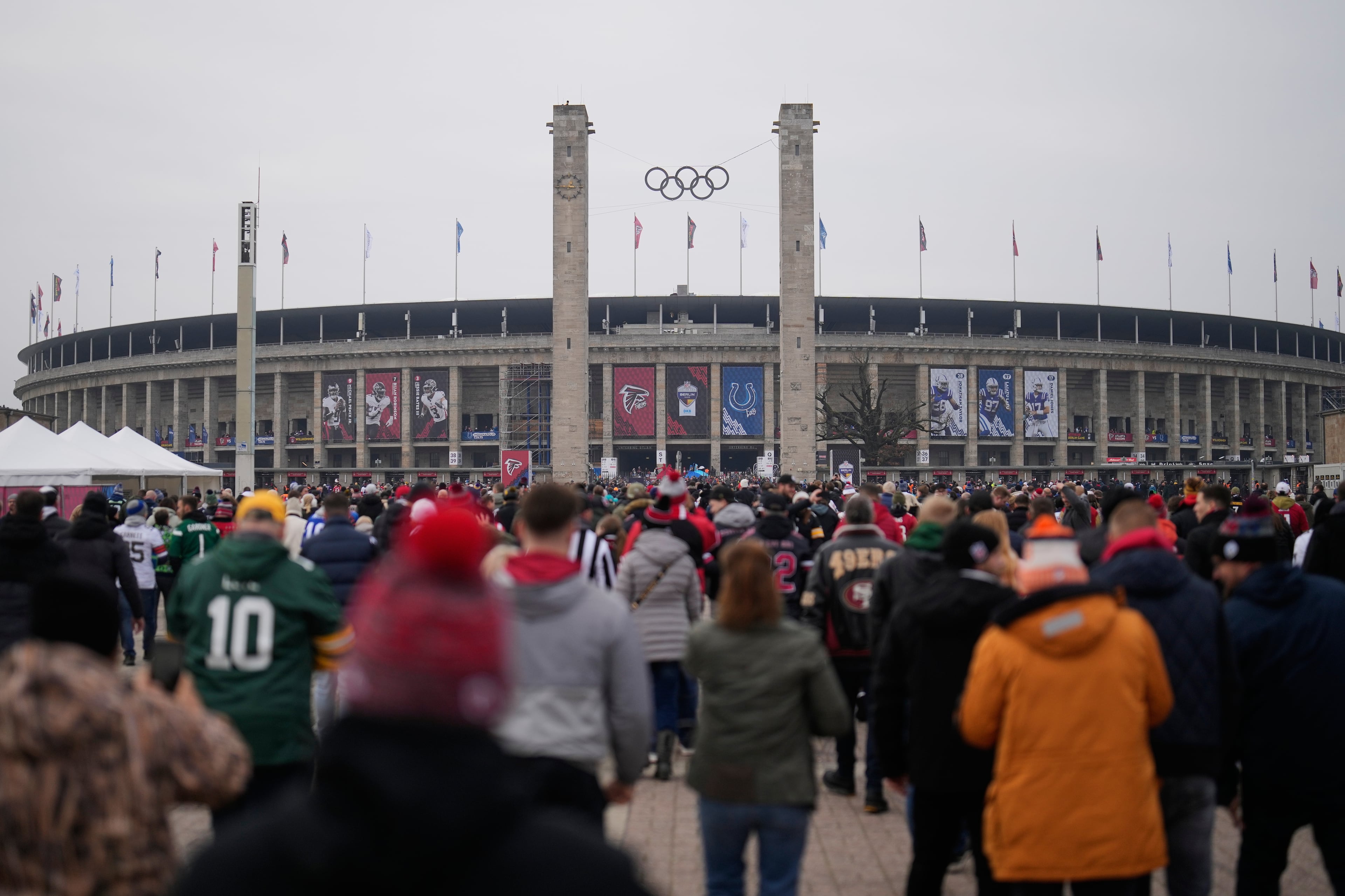 Supporters arrive at the Olympic stadium for the upcoming NFL game between the Indianapolis Colts and the Atlanta Falcons in Berlin, Germany, Sunday, Nov. 9, 2025. (AP Photo/Markus Schreiber)