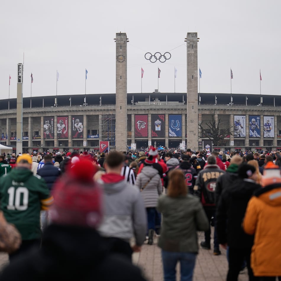 Supporters arrive at the Olympic stadium for the upcoming NFL game between the Indianapolis Colts and the Atlanta Falcons in Berlin, Germany, Sunday, Nov. 9, 2025. (AP Photo/Markus Schreiber)