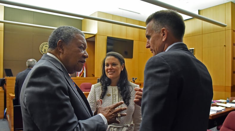 Robb Pitts (left), chairman of Fulton County Board of Commissioners, celebrates with Meria Carstarphen, superintendent of Atlanta Public Schools, and Jeff Rose (right), superintendent of Fulton County Schools after Judge Alan Harvey ruled to allow Fulton County to collect tax money on Tuesday, August 14, 2018. HYOSUB SHIN / HSHIN@AJC.COM