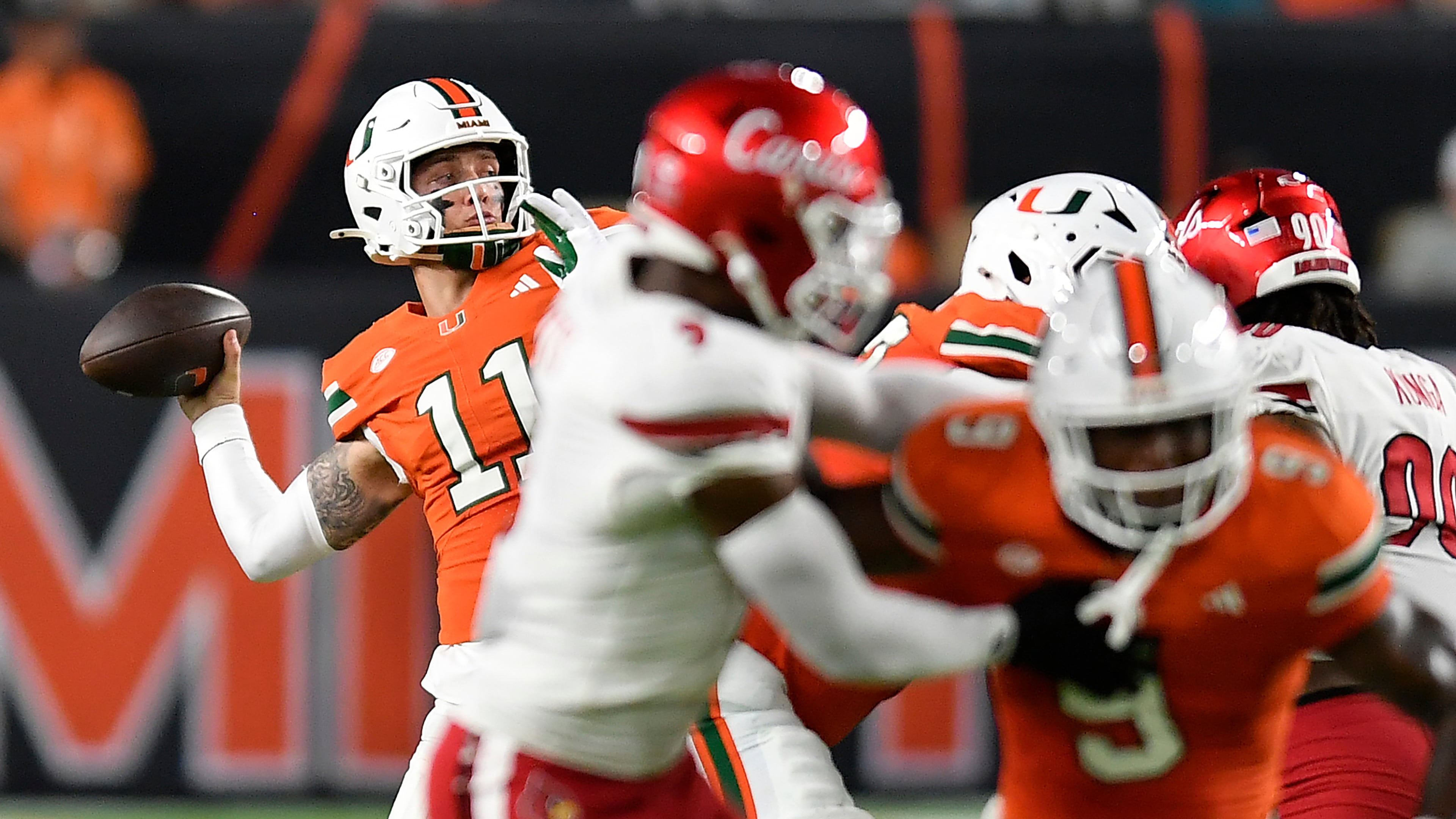 Miami quarterback Carson Beck (11) throws the ball during the first half of an NCAA college football game against Louisville, Friday, Oct. 17, 2025, in Miami Gardens, Fla. (AP Photo/Michael Laughlin)