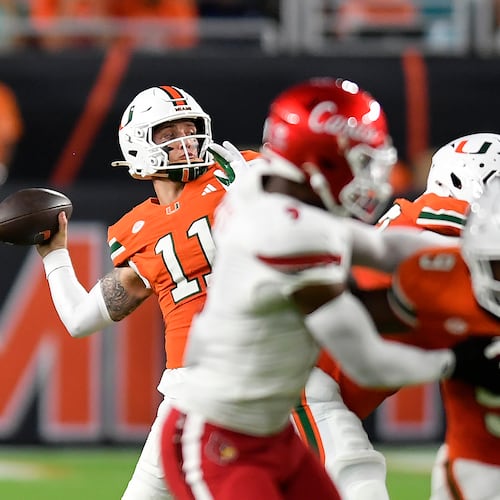 Miami quarterback Carson Beck (11) throws the ball during the first half of an NCAA college football game against Louisville, Friday, Oct. 17, 2025, in Miami Gardens, Fla. (AP Photo/Michael Laughlin)