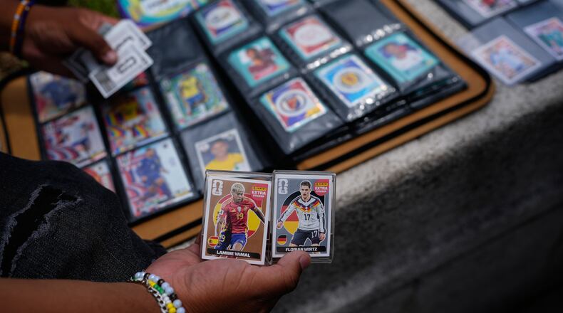 Youth exchange Panini World Cup stickers in Mexico City, Tuesday, June 16, 2026. (AP Photo/Marco Ugarte)
