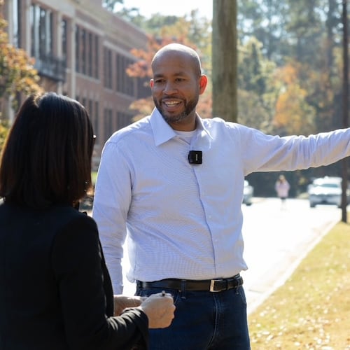 Former state Sen. Jason Esteves' Democratic campaign for governor is focused on economic opportunity. He said attending North Columbus High School (in background) opened opportunities that friends at other Columbus schools did not have. (Anna Girzone for the AJC)