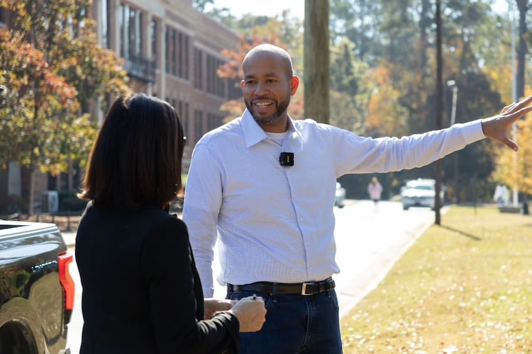 Former state Sen. Jason Esteves' Democratic campaign for governor is focused on economic opportunity. He said attending North Columbus High School (in background) opened opportunities that friends at other Columbus schools did not have. (Anna Girzone for the AJC)