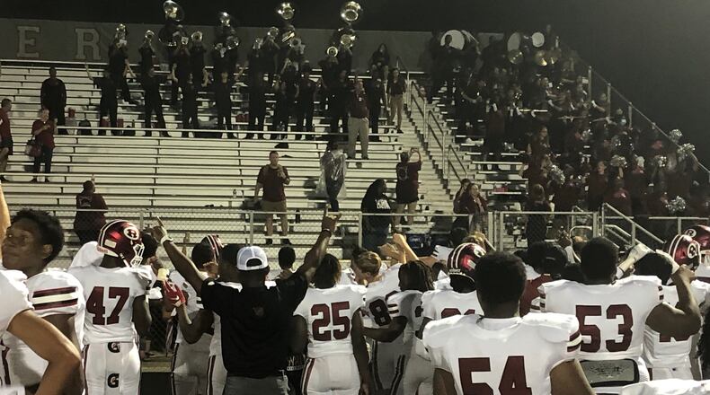 The Warner Robins football team celebrates their 50-34 win over Archer with the school's band, a weekly post-game tradition.