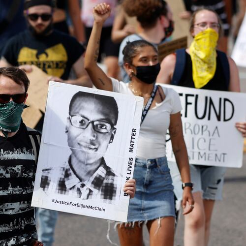 FILE - A demonstrator carries an image of Elijah McClain during a rally and march, June 27, 2020, in Aurora, Colo. Two paramedics were convicted Friday, Dec. 22, 2023, in the 2019 killing of McClain, who they injected with an overdose of the sedative ketamine after police put him in a neck hold. (AP Photo/David Zalubowski, File)