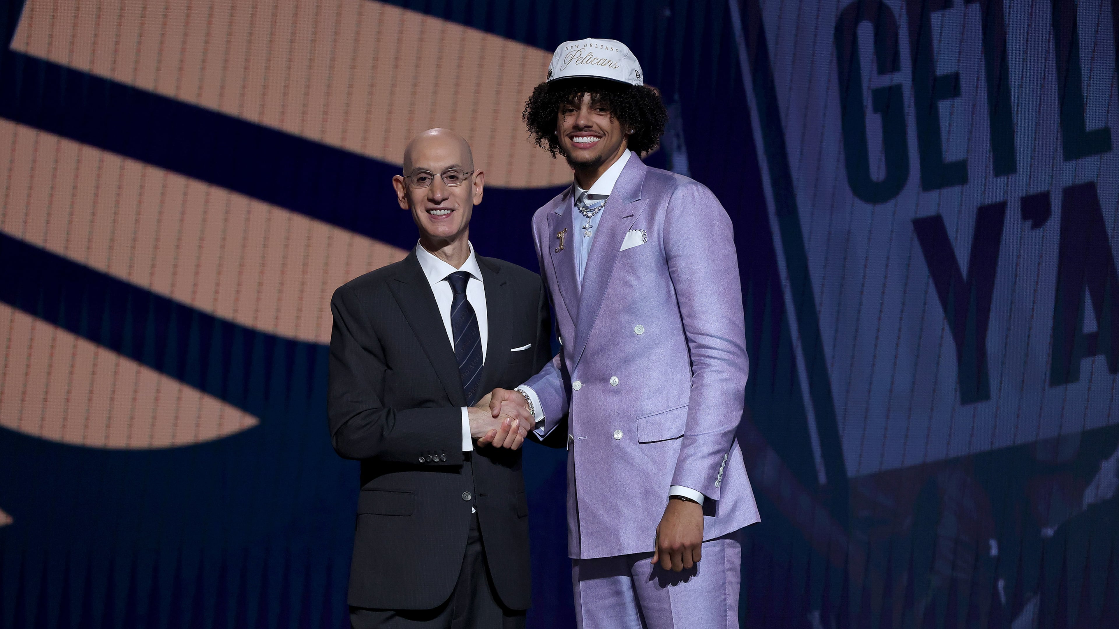 NBA Commissioner Adam Silver (left) shakes hands with Asa Newell after the former Georgia Bulldog was drafted 23rd overall by the New Orleans Pelicans during the first round of the NBA draft at the Barclays Center on Wednesday, June 25, 2025, in New York. (Sarah Stier/Getty Images/TNS)
