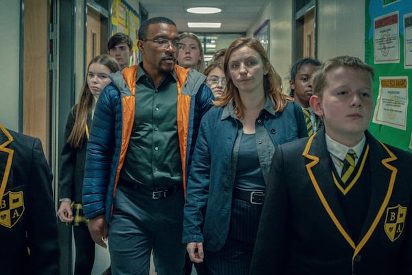 This image released by Netflix shows Ashley Walters, center left, and Faye Marsay, center right, in a scene from "Adolescence." (Netflix via AP)