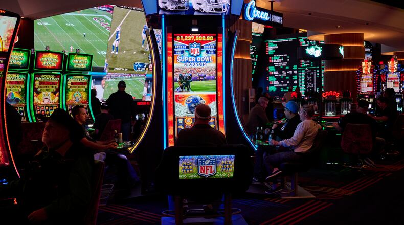 Casino patrons play an NFL-themed gambling machine at the Circa Resort & Casino in Las Vegas. Online sports gambling exploded across the United States following a 2018 Supreme Court decision that allowed states to legalize sports betting. Photo by Bridget Bennett/The New York Times