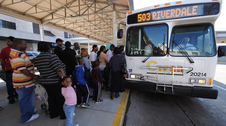 Riding for the last time, C-Tran customers stand in line to board the 503 to Riverdale on Wednesday, March 31, 2010 at Hartsfield Jackson International Airport. This was the last day that Clayton County would operate the C-Tran bus service.