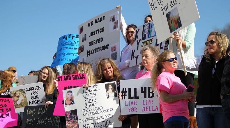 Family members and classmates of two high school girls killed in a wreck involving a state trooper stage a protest Friday in Carrollton, two days after a county grand jury decided not to bring charges against the trooper. TAYLOR CARPENTER / TAYLOR.CARPENTER@AJC.COM