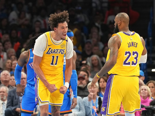 Los Angeles Lakers center Jaxson Hayes (11) celebrates with forward LeBron James (23) during the second half of an NBA basketball game against the Oklahoma City Thunder, Tuesday, April 8, 2025, in Oklahoma City. (AP Photo/Kyle Phillips)